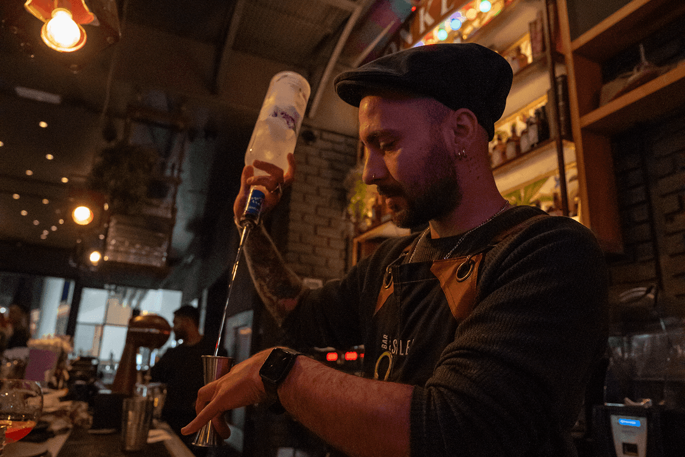 Bartender crafting a drink at Bar Du Soleil's main bar